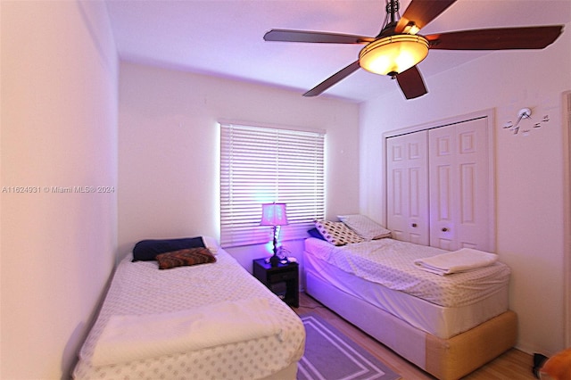 bedroom with ceiling fan, hardwood / wood-style floors, and a closet