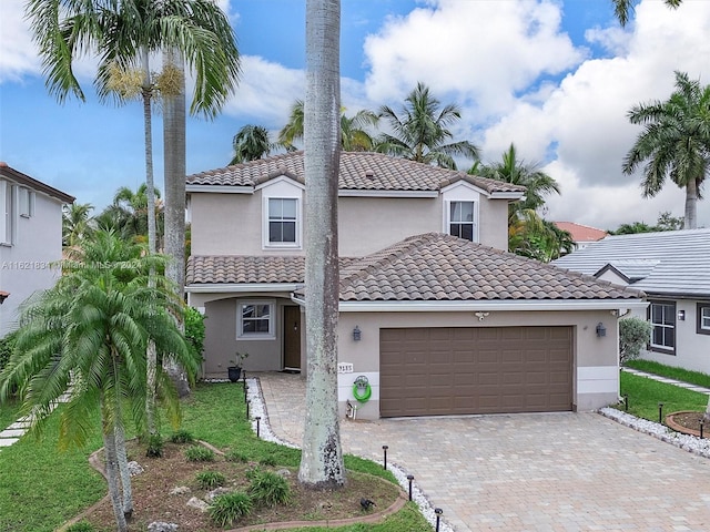 mediterranean / spanish-style house featuring a front lawn and a garage