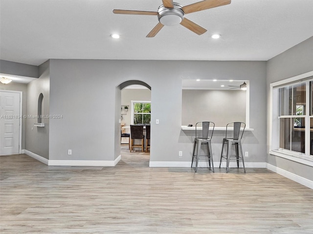 dining space with light hardwood / wood-style floors and ceiling fan