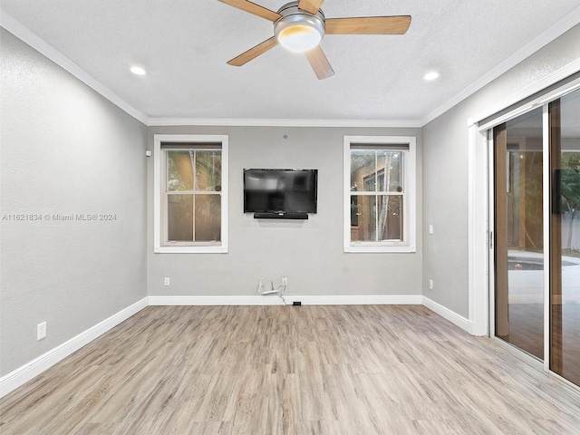 spare room with light hardwood / wood-style flooring, ceiling fan, and crown molding