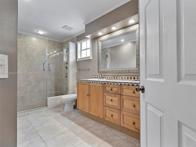 bathroom with vanity, crown molding, a shower with shower door, tile patterned floors, and toilet