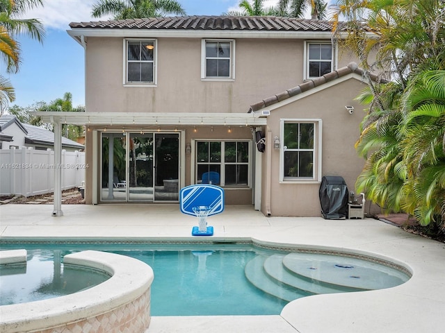 back of house with a pool with hot tub and a patio