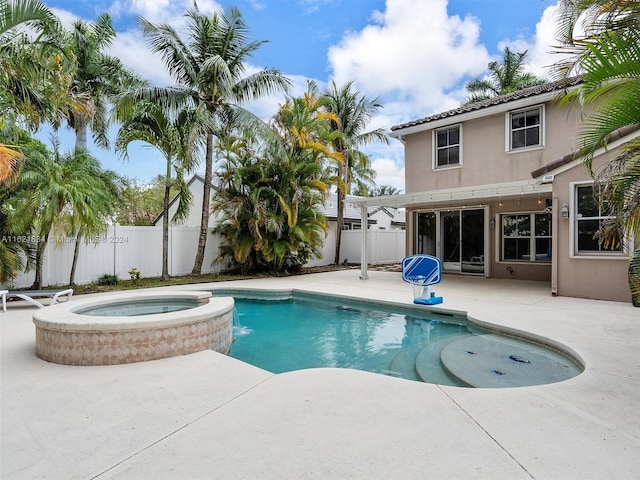 view of swimming pool with an in ground hot tub and a patio area