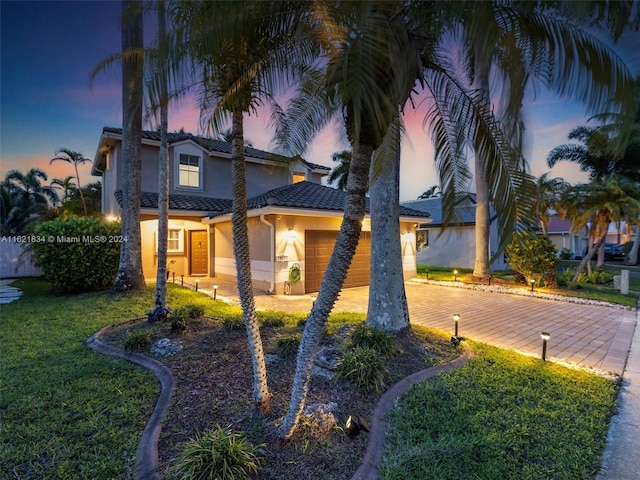 view of front facade featuring a lawn and a garage