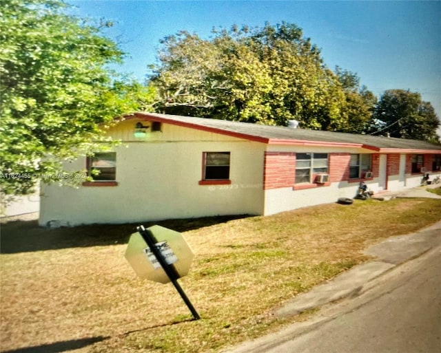 view of side of home featuring a lawn