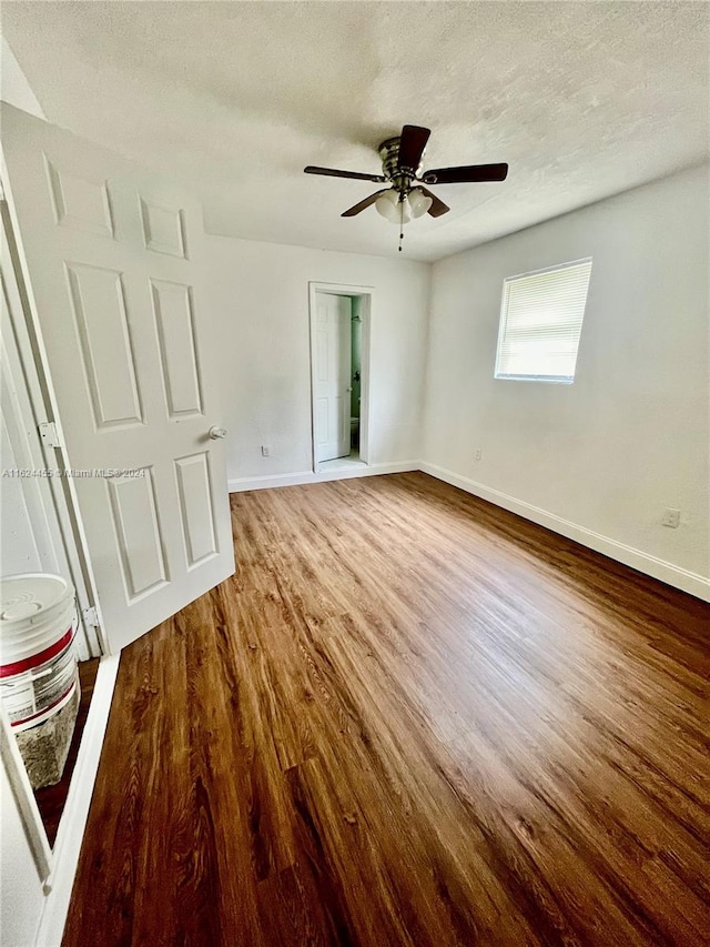 empty room featuring a textured ceiling, ceiling fan, and hardwood / wood-style floors