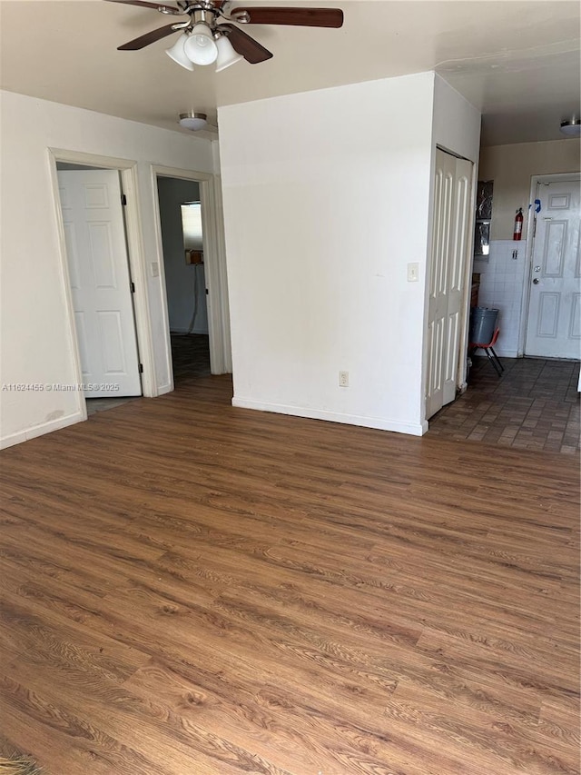 spare room featuring dark wood-type flooring and ceiling fan