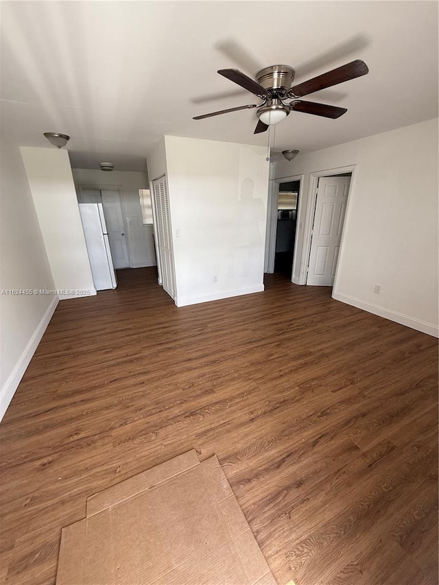 unfurnished room with ceiling fan and dark hardwood / wood-style flooring