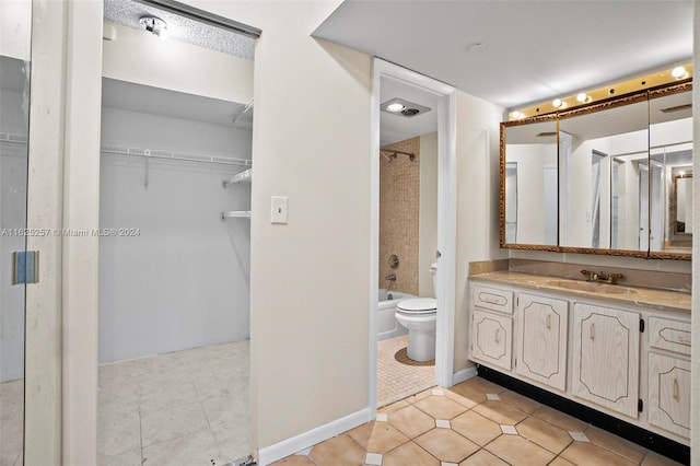 full bathroom with tile patterned floors, vanity, toilet, and tiled shower / bath