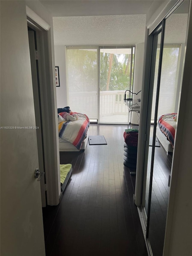 hallway featuring hardwood / wood-style flooring and a textured ceiling