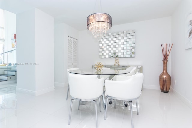 dining space featuring light tile patterned floors and a chandelier