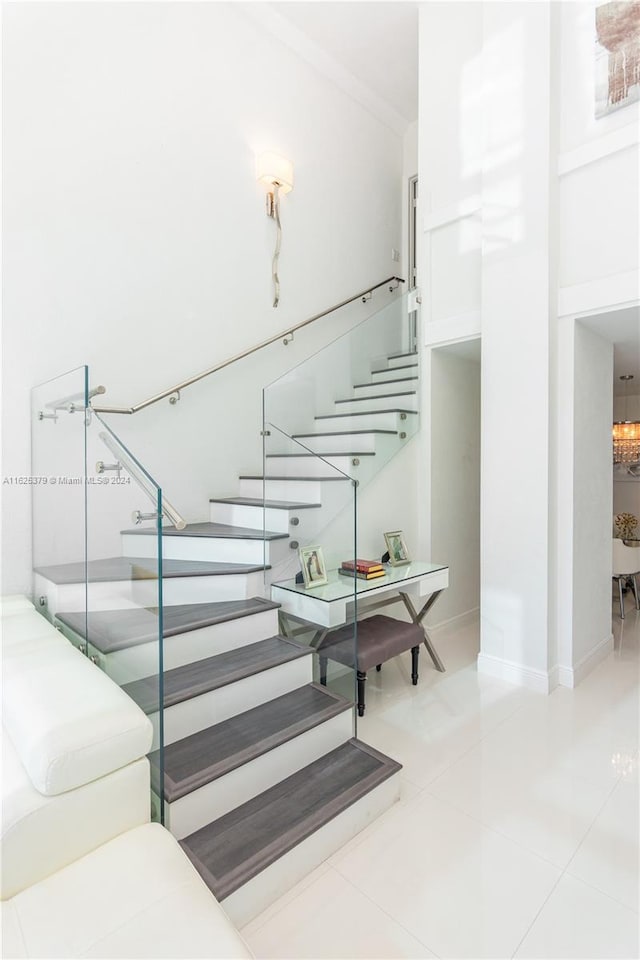 staircase featuring light tile patterned floors