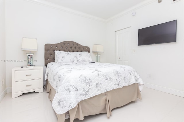 bedroom with crown molding, a closet, and light tile patterned floors