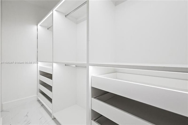 spacious closet with light tile patterned floors