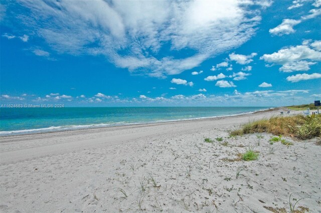 property view of water featuring a beach view