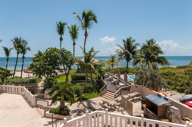 view of community featuring a patio, a pool, and a water view