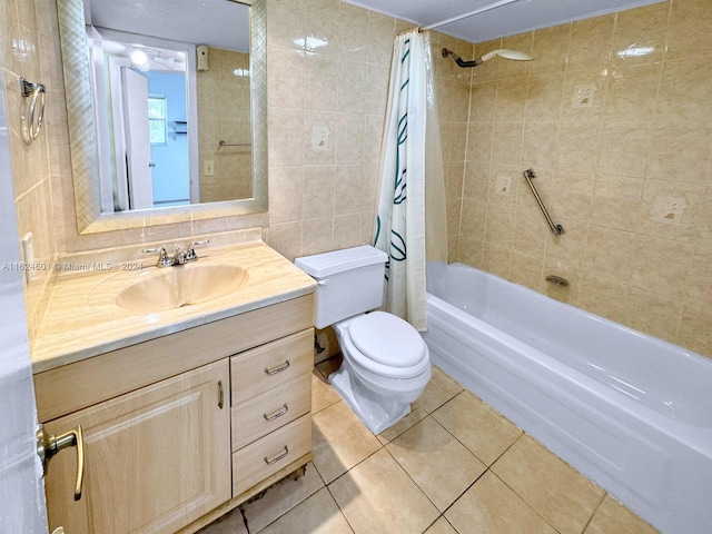 bathroom featuring tile patterned flooring, toilet, vanity, tile walls, and shower / tub combo with curtain