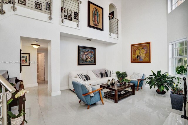 tiled living room with a high ceiling