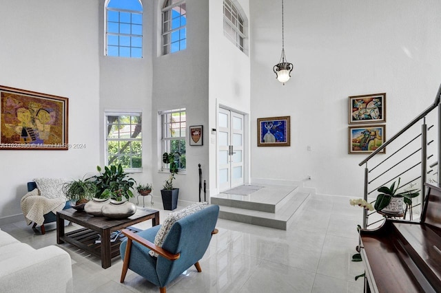 entryway with a high ceiling and light tile patterned floors