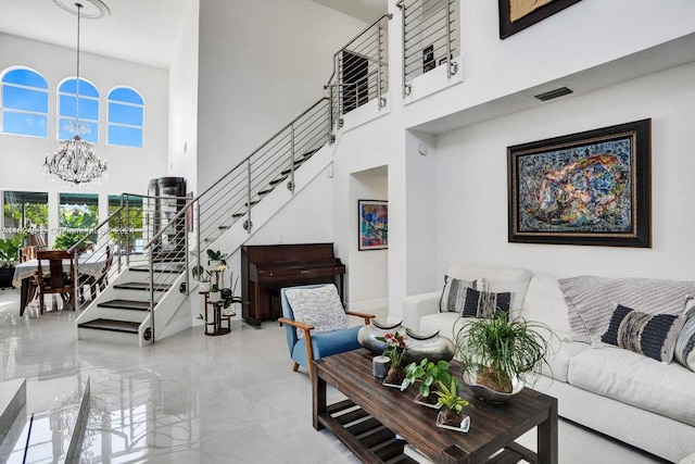 tiled living room with a high ceiling and an inviting chandelier