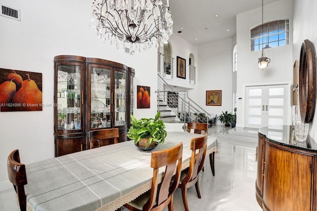 tiled dining space with a high ceiling