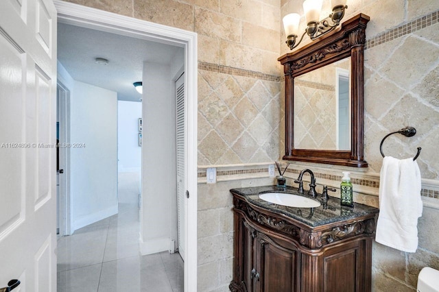 bathroom featuring vanity, tile walls, and tile patterned floors