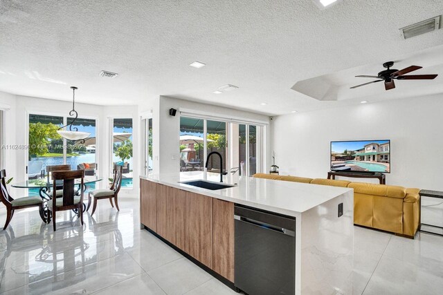 kitchen with hanging light fixtures, black dishwasher, ceiling fan, and light tile patterned flooring