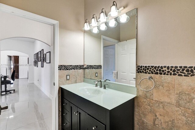 bathroom with vanity, tile patterned floors, and tile walls