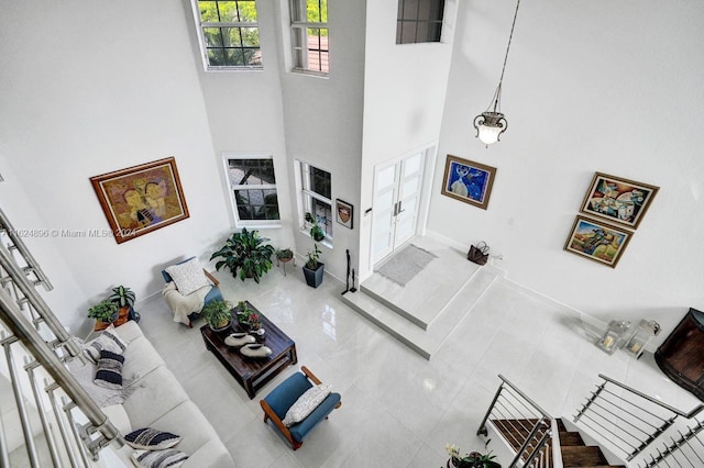 living room featuring tile patterned flooring and a high ceiling