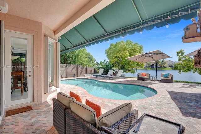 view of pool with an outdoor living space and a patio