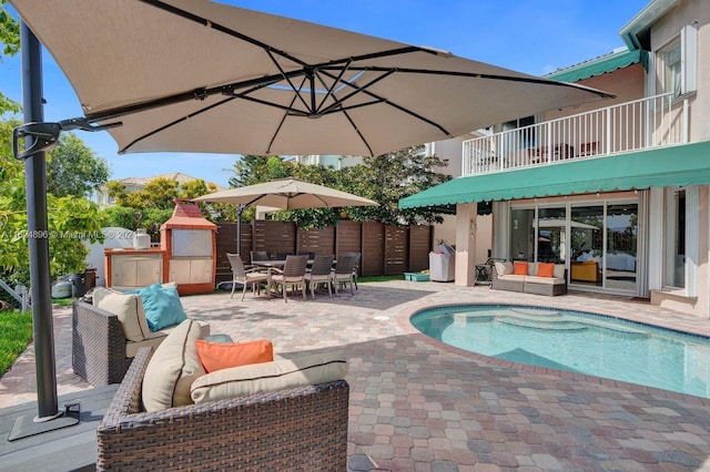 view of pool with outdoor lounge area and a patio