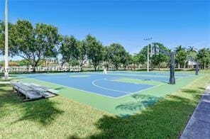 view of sport court featuring a yard