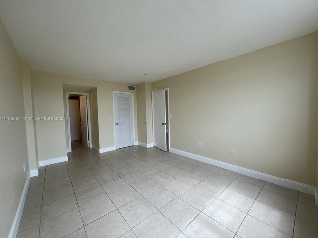 15600 NW 7th Ave Unit 306, Miami, FL 33169 - unfurnished bedroom with light tile patterned flooring and a closet