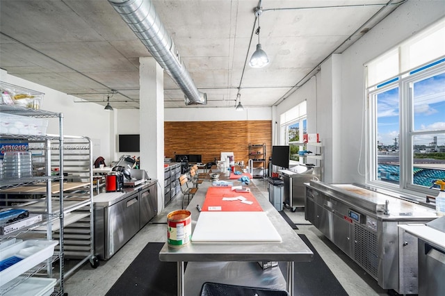 kitchen with concrete flooring and pendant lighting