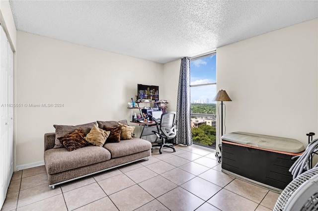 living room featuring floor to ceiling windows, a textured ceiling, and light tile patterned floors