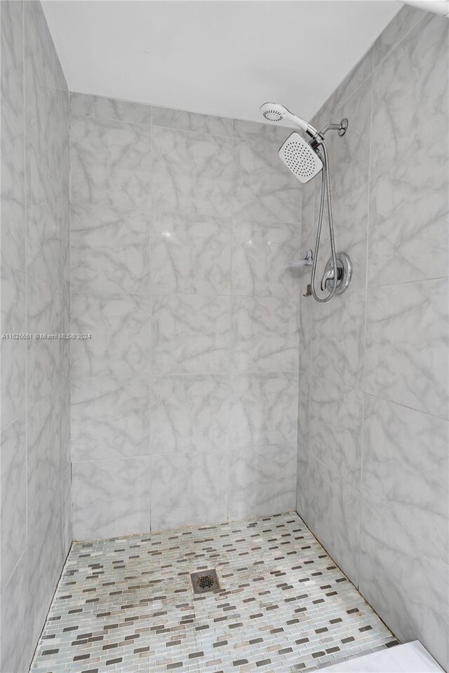 bathroom with a tile shower