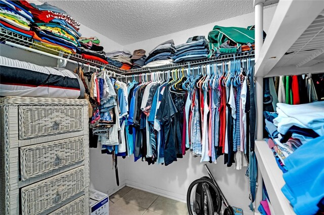 spacious closet with tile patterned floors