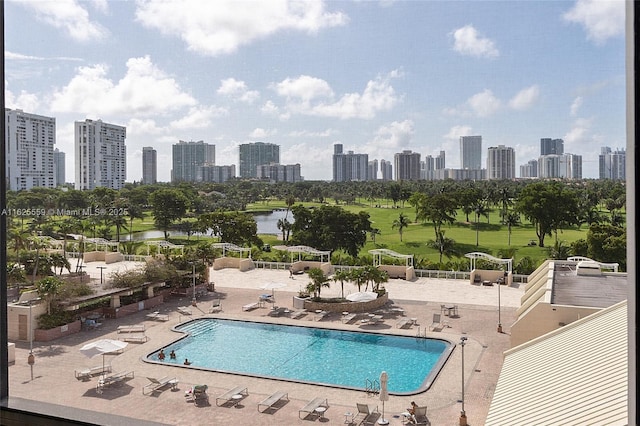 view of pool featuring a patio and a water view