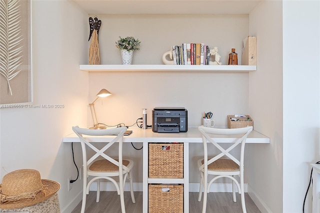 office area featuring wood-type flooring and built in desk