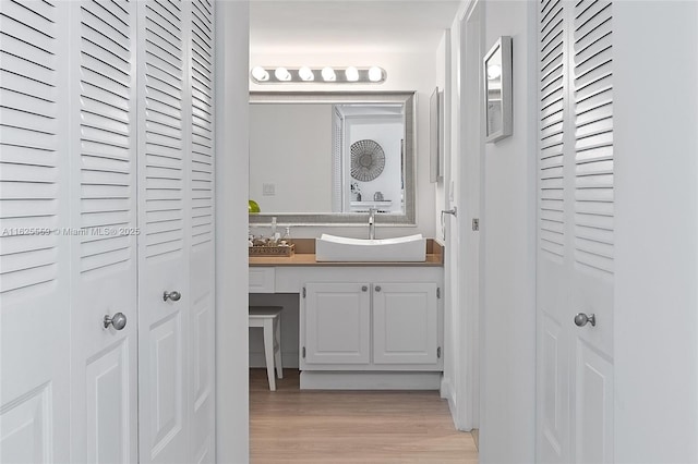 bathroom with vanity and hardwood / wood-style floors