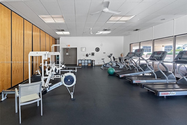 gym with a paneled ceiling