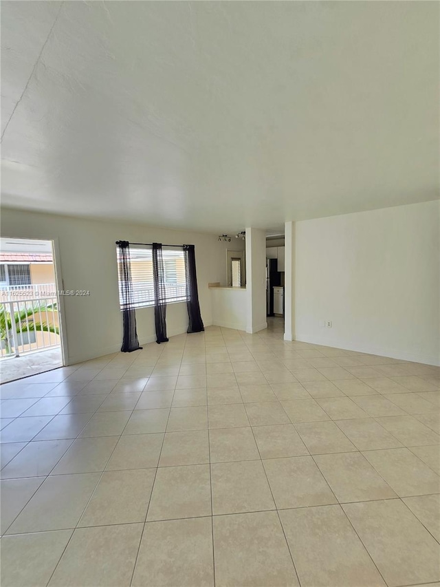 unfurnished living room with a wealth of natural light and light tile patterned floors