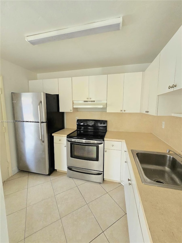 kitchen with sink, light tile patterned flooring, white cabinets, and stainless steel appliances