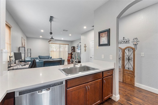 kitchen with dark hardwood / wood-style flooring, sink, dishwasher, and decorative light fixtures