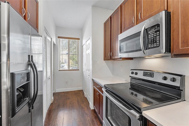 kitchen with dark hardwood / wood-style flooring and stainless steel appliances