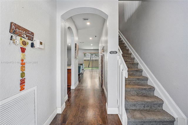 stairs featuring hardwood / wood-style floors