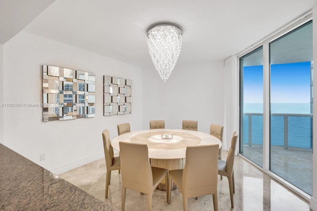 dining area with light tile patterned flooring, plenty of natural light, and a notable chandelier