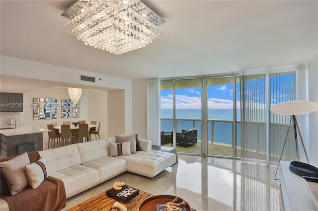 tiled living room featuring sink, a water view, floor to ceiling windows, and a notable chandelier