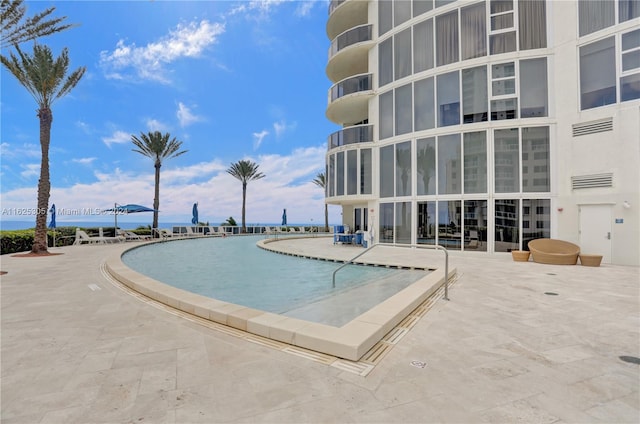 view of swimming pool featuring a patio area