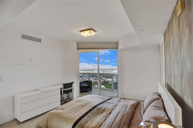 bedroom featuring a wall of windows and access to exterior